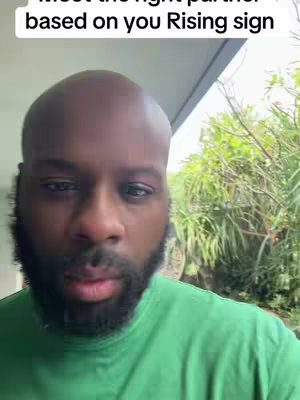 A man with a beard wearing a green shirt is against a background of greenery. Text overlays the top part of his head.