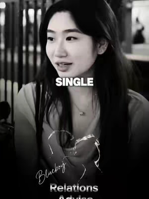 Black and white image featuring a woman looking towards the left side of the frame with the text "SINGLE" overlaid in white. Below the woman and text is the title"Blueboy Relations Advice" in a white, stylized font. Additionally, there is a heart shaped design.