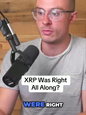 A man with short brown hair and glasses is positioned in front of a wooden background, a black microphone to his left, with overlaid text reading, "XRP Was Right All Along?" and "WERE RIGHT."