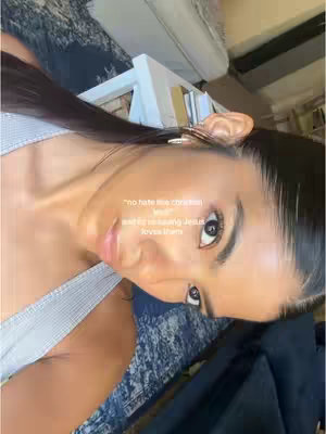 A woman angles toward the camera, her face in close-up. She wears a light-colored top, and her dark hair is neatly styled. Text is overlaid in the image.