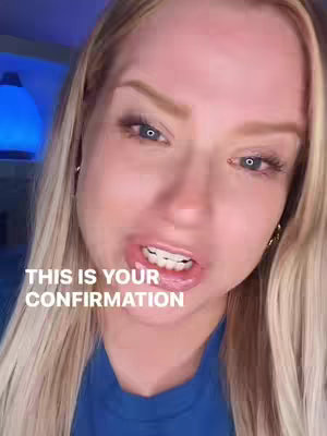A close-up shot of a woman's face, with blonde hair and blue eyes, slightly open mouth. There is white text overlayed on the image. Lighting appears to be softly diffused.