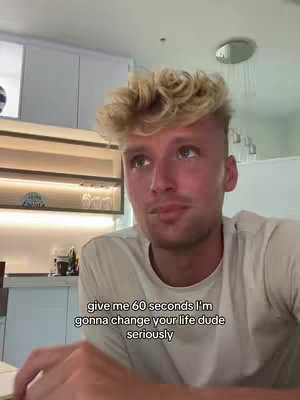 A medium shot shows a young man with light-colored hair, looking up and slightly to the left. He has a neutral expression, and the background features a kitchen setting. Text is overlaid at the bottom, offering a promise of life improvement.