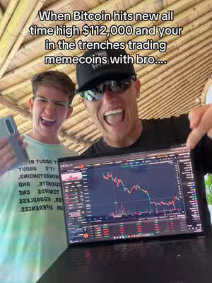 Two young men are enthusiastically facing the camera. One holds a phone and grins, the other holding a laptop displaying a stock chart. The backdrop is a bamboo-style roof.