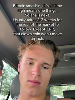 A young man is sitting in a car, looking towards the camera. Text overlayed on the image reads Bitcoin smashing its all time high means one thing... Solana is next... Except XRP, that clown coin won't move an inch.