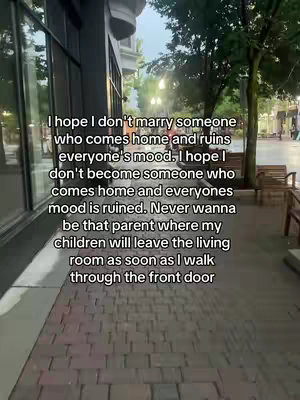 The image shows a brick walkway with a building on the left and foliage and benches on the right. Text is overlayed on the image, white text on top of the scene itself.