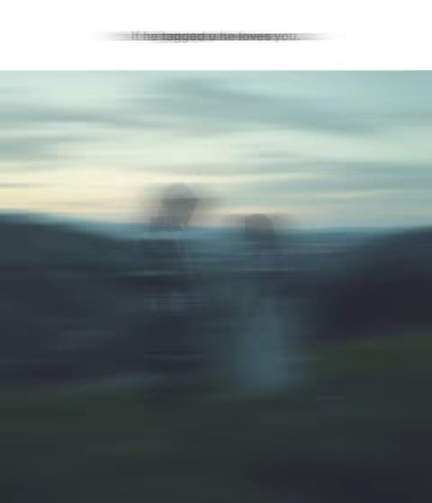 An image with a blurred background featuring soft pastel colors, primarily blues and greens. Hints of what appear to be figures are visible in the center, which are obscured by the blurring effect.