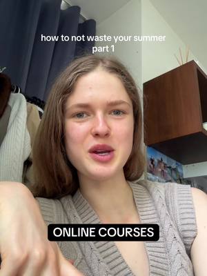 A young woman is shown from the chest up, sitting indoors and talking. Behind her is a messy background with clothing items hanging. The text overlay says, 'how to not waste your summer part 1'. Below this is a black box with the text 'ONLINE COURSES'.