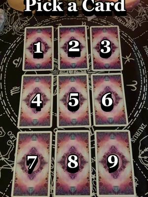 The cover image presents nine tarot cards arranged face-down on a dark patterned surface, each card featuring a large number from 1 to 9. Above the cards, the text 'Pick a Card' is displayed, suggesting an interactive tarot reading theme.
