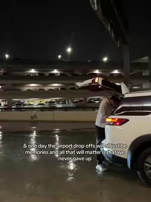 The cover image shows a nighttime scene at an airport. A person, who appears to be male, is standing next to an open car trunk, illuminated by a combination of the car's interior lights and the airport's overhead lighting. The background has multiple levels of parking structures and illuminated signs. The overall mood seems to be somewhat melancholic due to the night setting and implied departure.