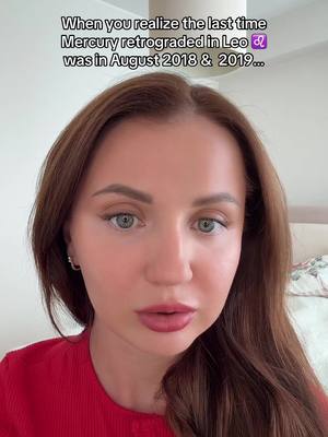 A medium shot shows a woman with long brown hair and a red top looking directly at the camera. The background is a soft blur, with part of a bed visible on the right. Text at the top of the frame informs the viewer of a moment in time related to Mercury's retrograde motion.