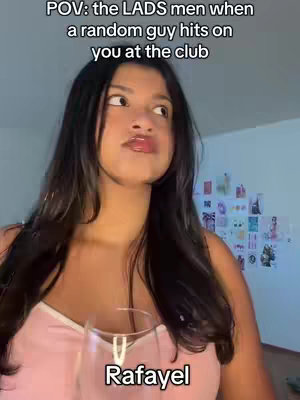 A woman with dark hair is shown from the chest up, holding a glass with a pink top looking off to the sides, the text overlayed is "POV: the LADS men when a random guy hits on you at the club". There is a secondary text at the bottom that says Rafayel.