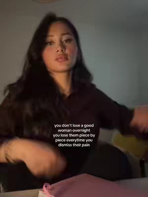 A young woman, with long dark hair, looks up at the camera. Text overlays on the image.