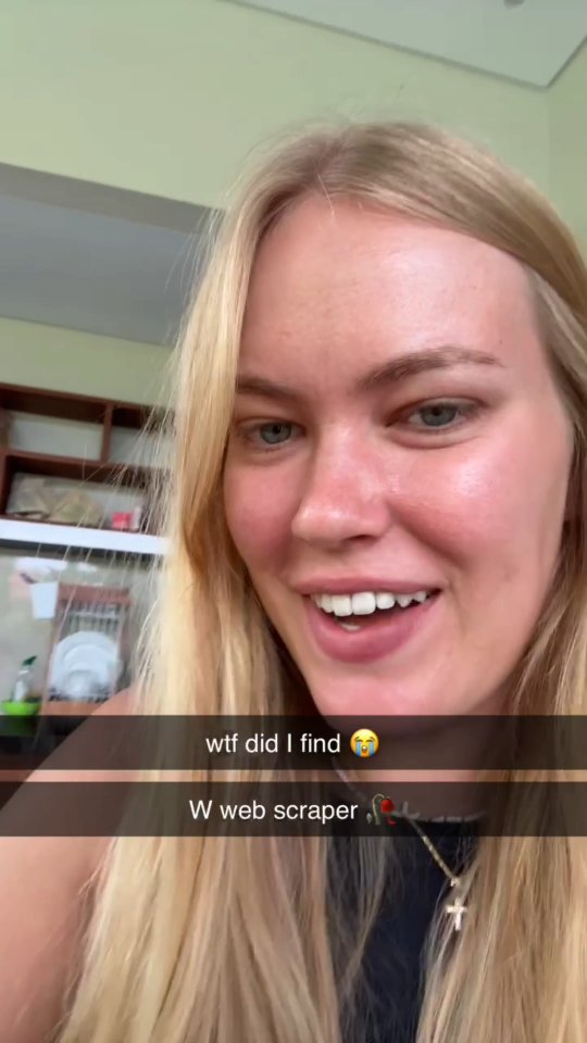 A selfie-style video cover image featuring a young woman with blonde hair. She has blue eyes and is smiling widely, showing her teeth. Text overlays the image in a dark box, with a casual, friendly tone. The background is a neutral kitchen space.