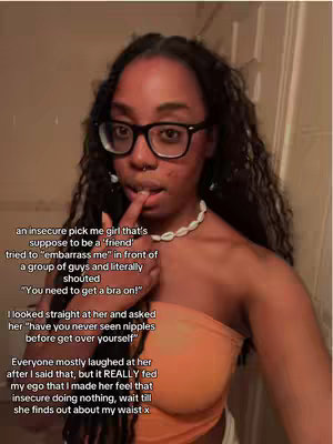 A woman with dark hair and glasses is shown from the chest up, with text overlayed on the image. She is looking slightly to the side with a contemplative expression, finger touching her lower lip. She is wearing an orange tube top and a necklace.