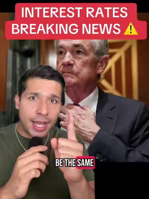 The cover image shows a man speaking and pointing. Behind him is a picture of another man dressed in a suit. The top of the image says 'INTEREST RATES BREAKING NEWS!' in large bold red text. At the bottom is the text 'BE THE SAME' also in red.