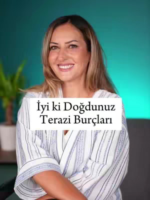 A woman with long, highlighted blonde hair smiles at the camera. She wears a white and light blue striped robe. A white box with the caption "İyi ki Doğdunuz Terazi Burçları" is on top of her. Green wall and a plant in a white pot can be seen behind her.