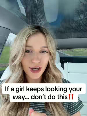 A woman with long blonde hair is seated in a car, talking into the camera. She has a neutral expression, and the background shows a cloudy sky and some trees. A text overlay at the bottom provides the video's hook.