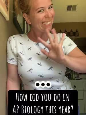 A woman with blonde hair in a bun is smiling widely, gesturing with her right hand, and wearing a white t-shirt with small black dragonfly patterns. The bottom of the image contains a black banner with white text.