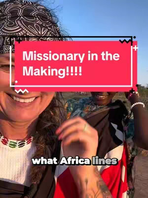 A selfie-style image with three women smiling. The main subject, on the left, wears a black and white patterned headscarf and a colorful beaded necklace. She looks directly at the camera. Text overlays are placed on the image. Behind the main subject, another woman is partially visible, also smiling and wearing a headwrap. Further back, a third person is seen. The background appears to be a sunny outdoor setting.
