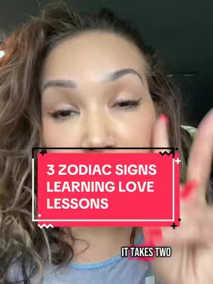 A woman is shown from a medium close-up, with her face and upper body visible. She's holding her right hand up near her face, with her index finger pointed up. A red rectangle with white text overlayed in the image. The text reads 3 ZODIAC SIGNS LEARNING LOVE LESSONS. Below it, smaller white text is visible, which is 'IT TAKES TWO'.