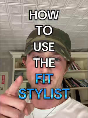 A man is pointing towards the camera, with overlaid text in a square-tiled room. He wears a green camouflage cap and a white shirt, the text is stylized with bold white outlines and blue fills.