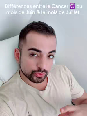 A selfie-style shot featuring a man with a trimmed beard and short dark hair. Text overlays the image. The man is looking directly at the camera. The background is a softly lit, monochrome setting.