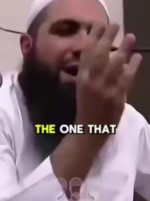 The cover image features a man, possibly of Middle Eastern descent, with a beard and wearing a white cap and shirt. He is in a close-up shot, gesturing excitedly with his right hand and arm. The background is blurred, but appears to be an interior setting, likely a room with a light-colored wall. A text overlay with the words 'THE ONE THAT' is positioned across the lower part of the image, drawn with a yellow background and black outline.