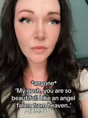 A close-up shot featuring a woman with dark hair and fair skin, looking directly at the camera with a neutral expression. She has long eyelashes, and her lips are slightly parted. Text overlay is visible.
