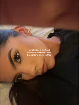 The image is a close-up shot showing a young woman lying down, her face filling the frame. She's looking towards the camera with a slight smile, and her dark hair is spread out. Text is superimposed across her face, a mix of clarity and emotion.
