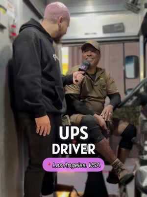 The image shows two men inside a UPS truck. The man on the left is wearing a black hoodie. The man on the right is a UPS driver holding a microphone, wearing a brown uniform and cap. Text overlays read "UPS DRIVER" and "Los Angeles, USA." The composition is clearly focused on interviewing the driver.