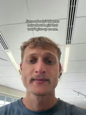 The cover image is a selfie-style shot featuring a man from the chest up. He has short, lightly-colored hair, a full mustache, and is wearing a dark t-shirt. The background indicates an indoor setting, and there is overlaid text at the top of the image.