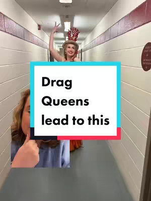 The image shows a hallway scene with a woman at the far end, wearing a costume - a red headpiece and an orange dress. In the foreground, a person's hand gives a thumbs up, left of a text box that says \"Drag Queens lead to this\".