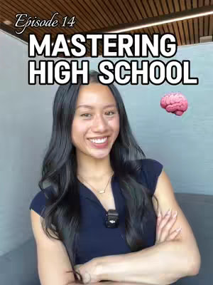A smiling young woman with long dark hair is centered in a video still. She is wearing a dark blue top and a small microphone is attached to her clothing. A pink brain emoji is placed on the right. White text, "MASTERING HIGH SCHOOL" is placed above her in the center.