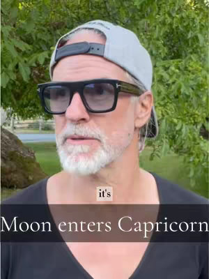 A man wearing sunglasses and a cap stands in front of a natural background. Text overlay indicates the video focuses on astrology.