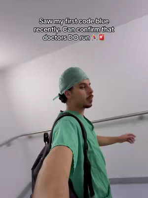 A man in medical scrubs and a scrub cap walks towards the camera on a staircase. Text overlays the image.