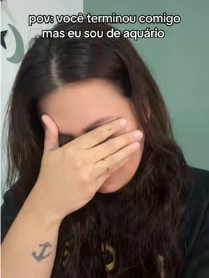 A young woman with dark hair covers her face with one hand, showing distress. The image is a close-up, focusing on her face and hand, suggesting an emotional moment. The background is out of focus.