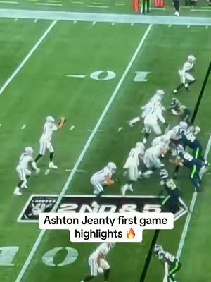 An overhead shot from a football game, with players in white and navy uniforms on a green field. Text overlay identifies Ashton Jeanty and the action as highlights.