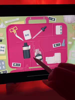 The cover image shows a child's hand holding a digital pen, interacting with a screen that displays a pink first aid kit. The kit is filled with various medical supplies rendered in a cartoon style, including scissors, band-aids, a dropper, and bottles. The background is a light green color. The perspective is from the top-down.