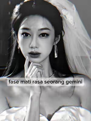 A grayscale image of a woman in a bridal-style outfit, with a veil and her hand near her face. Text overlayed in a white rectangular box at the bottom reads "fase mati rasa seorang gemini".