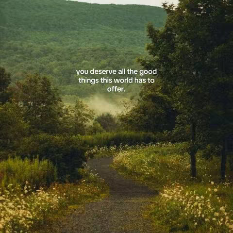 A scenic image of a pathway winding through a lush green landscape. The path, made of gravel, leads into the distance, surrounded by vibrant green flora with patches of small white flowers. In the background, a large, verdant hillside fills the frame. Overlayed on the image is a quote in white text.
