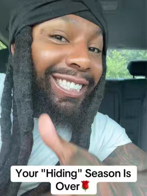The cover image features a smiling Black man with a black durag and dreadlocks. The image is a close-up shot of his face, and he is seated inside a vehicle, possibly a car. Text overlayed at the bottom of the image reads, Your Hiding Season Is Over with a rose emoji. The background is out of focus with details of the inside and outside of a car.