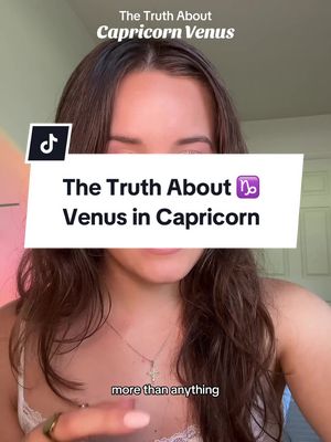 A woman with long brown hair is centered in a selfie-style shot. Text overlays indicate video content related to Venus in Capricorn. The background appears to be indoors.