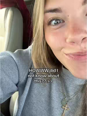 A close-up selfie of a young woman inside a car, focusing on her face. She's wearing a gray sweater and a necklace with a cross pendant. The background shows the interior of the car, and text is overlaid on the image.