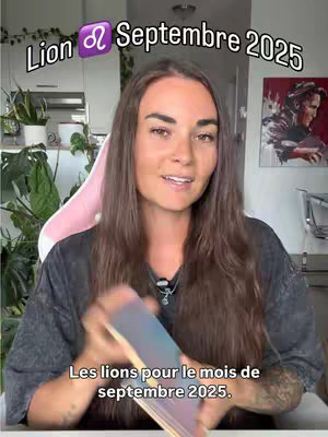 A woman with long, brown hair is centered in a frame. The top text overlay says 'Lion ♌️ Septembre 2025'. She smiles at the camera, holding an open deck of cards up in front of her. The background has a hint of a room with plants. The bottom text mentions, 'Les lions pour le mois de septembre 2025.'