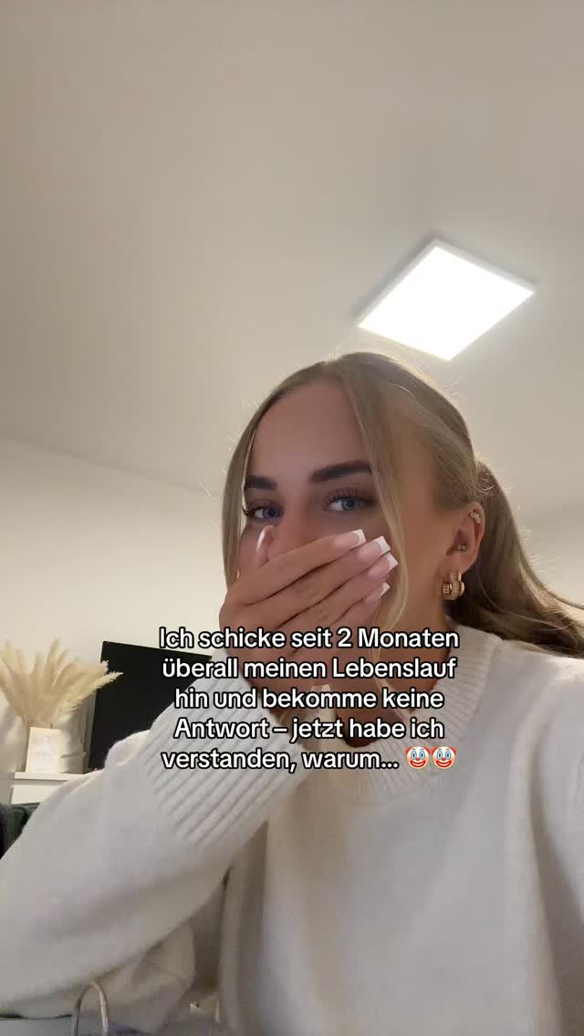 A woman with blonde hair and fair skin is the focal point, covering her mouth with her hand. The background is a domestic interior with a soft light fixture. Text overlays appear in white, conveying a message. The overall setting is likely indicating a personal or relatable content creation.