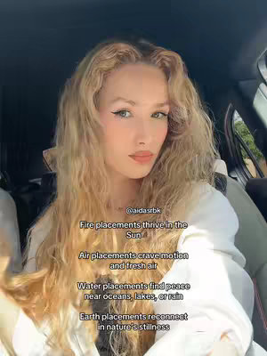 A woman with long blonde hair sits in what appears to be a car, facing the camera. Text overlays provide astrology-related insights, and the aesthetic is clean and natural.