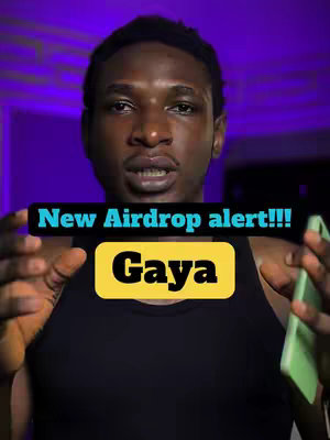 A man with dark skin is centered in the frame, wearing a black tank top. Behind him is a blurry purple background. Overlayed on the image are two rectangular text elements. The top one, in white sans-serif font, reads, "New Airdrop alert!!!". Below it is a yellow rectangle with the name "Gaya" in a bold, dark font.