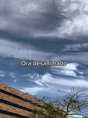 The cover image shows a view of a cloudy sky, with a building and the branches of a tree in the foreground. The sky has many dark grey clouds with some blue visible. The building has horizontal lines in a brown color and the tree branches are dark and reach upwards. Text is overlaid across the image.
