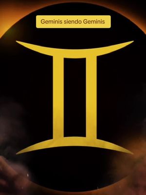 The cover image features the Gemini zodiac symbol, a stylized capital 'II' in gold, set against a dark background with swirling dark and golden colors. Across the top is a yellow rectangular text overlay that reads 'Geminis siendo Geminis'.