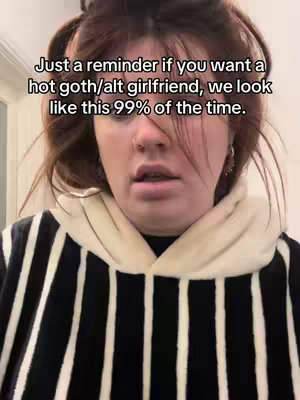 The image shows a close-up of a person with light skin, their face framed by dark hair, and wearing a striped hoodie. The image is lit with natural light, which highlights the skin tone and the textures of the hair. Above the person's head, there is some text that is not a natural part of the image.